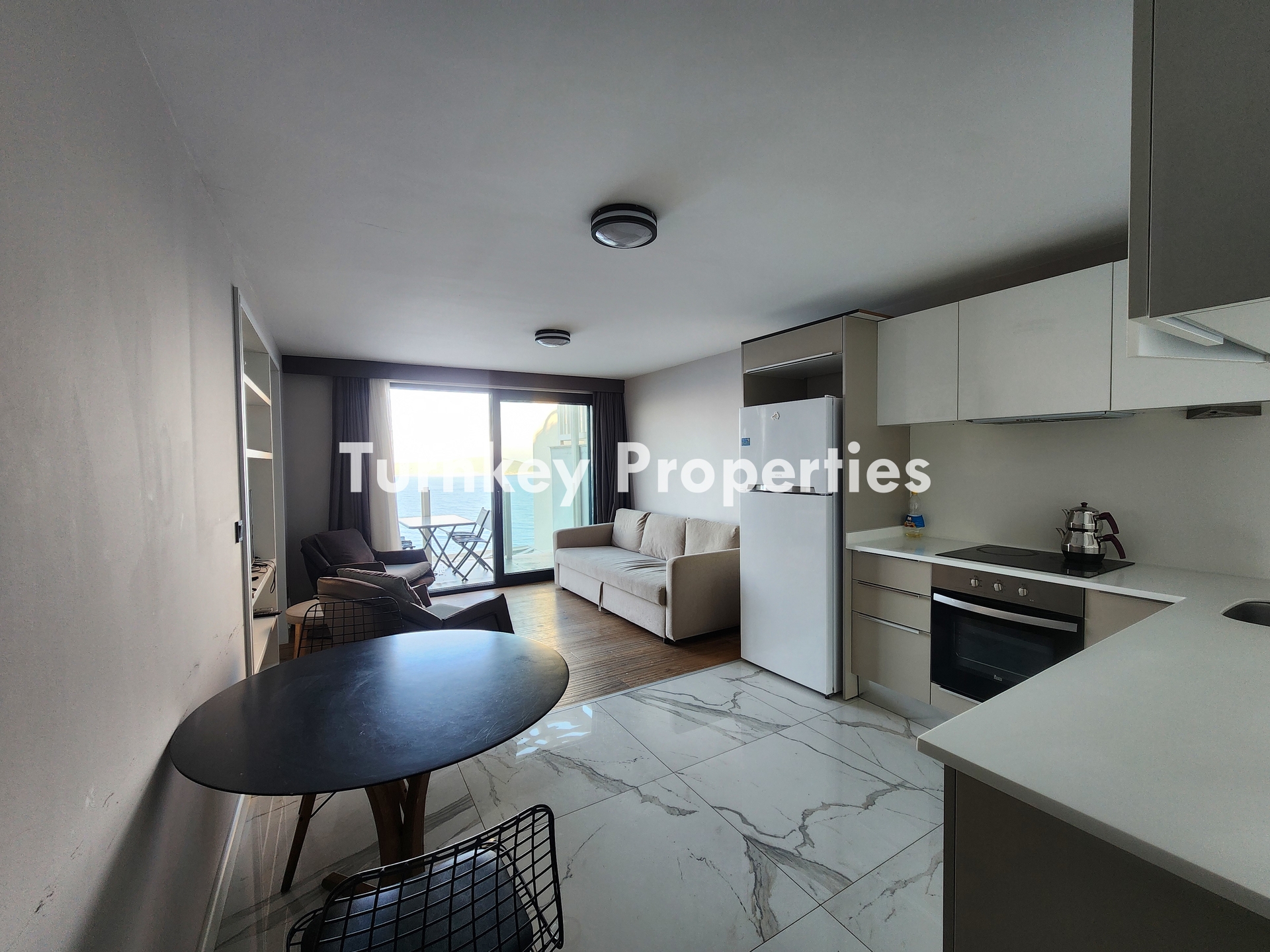 Gümüşlük Koyunbaba’da Deniz Manzaralı Satılık Daire Denize Sıfır